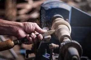 wood lathe machine in use to shape wood